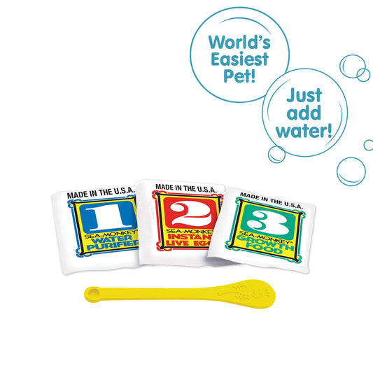 Three packets, numbered 1, 2, and 3 from left to right. There is a small yellow Sea-Monkeys spoon laying in front of the packets. There are two callouts in circles. One reads "World's Easiest Pet!" and the other reads "Just add water!"